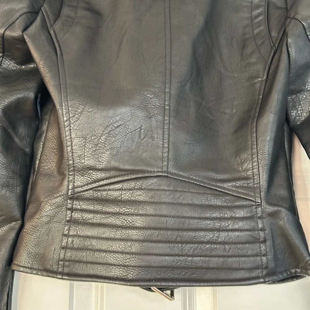 Edgy Moto jacket with studs, perfect layering over jeans or a skirt